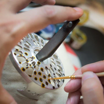 A Fish Skin Finish is painted by hand before anodizing on the Abel Fly Reel